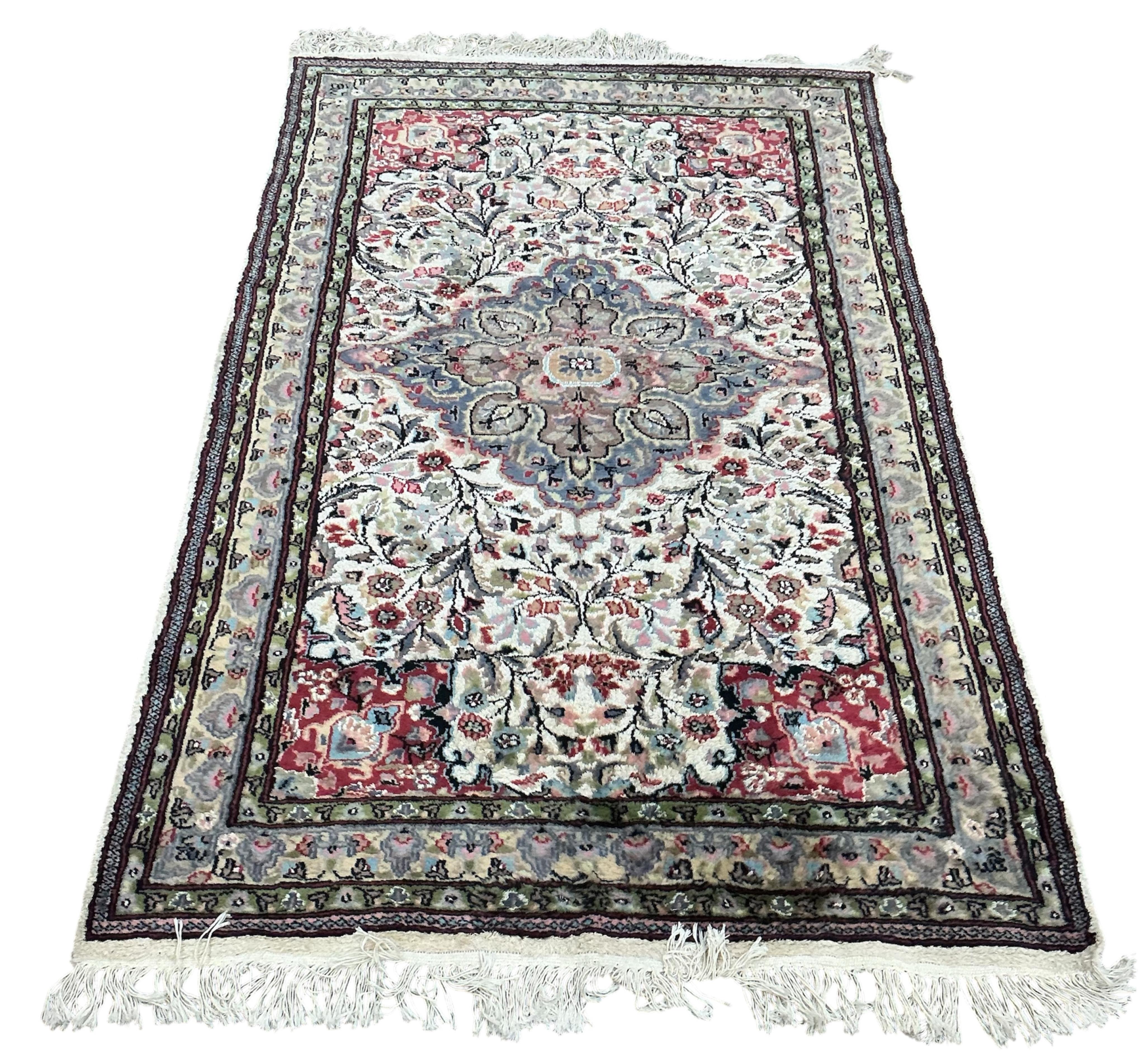 A Pakistan ivory ground part silk medallion rug, 196cm x 125cm